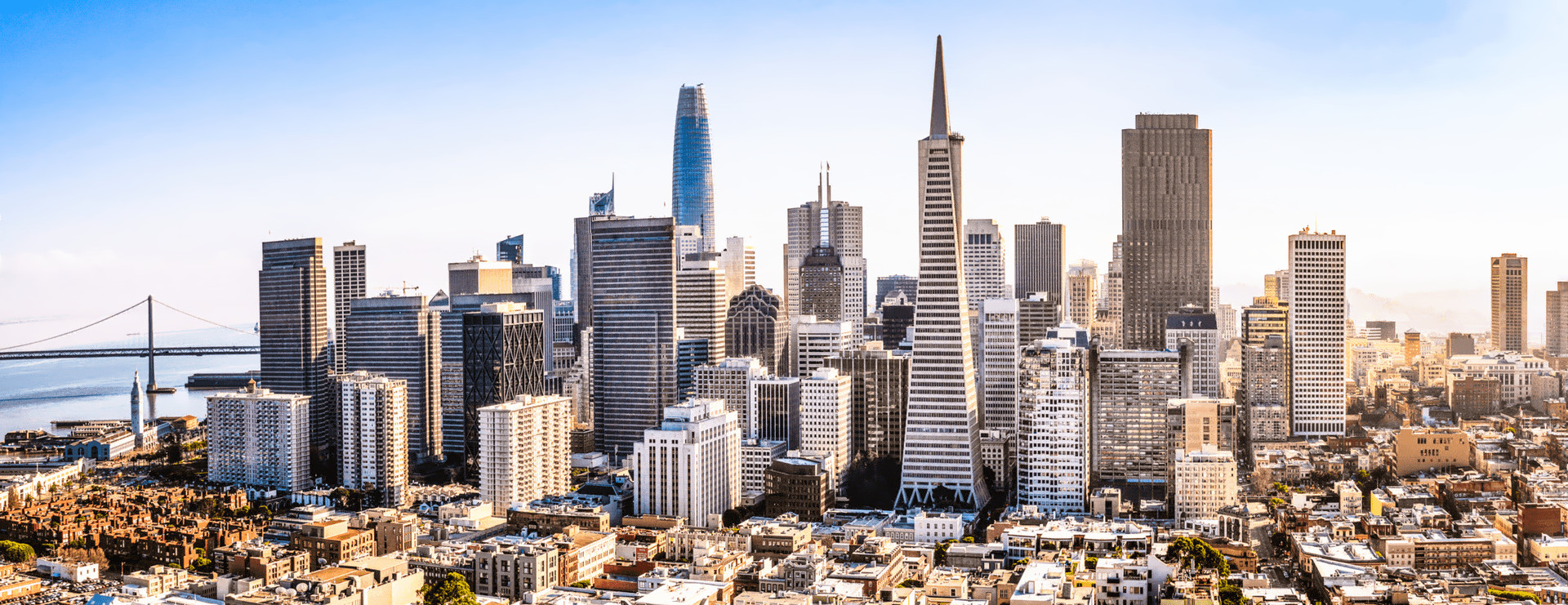Views of San Francisco: the downtown skyline, the Golden Gate Bridge rising above the fog, and Coit Tower with the downtown skyline